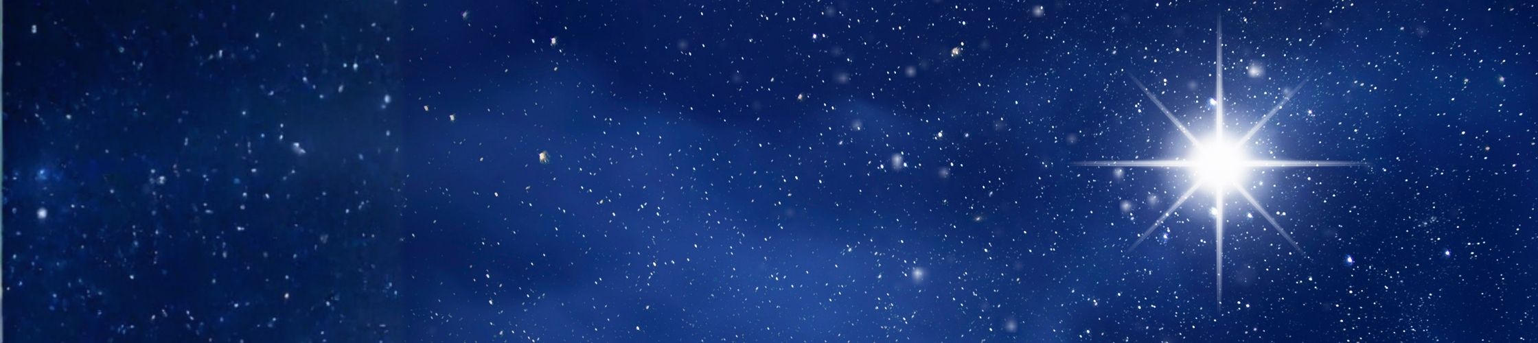 A clear blue night sky with a Christmas Star shining brightly.